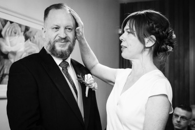 brides wipes tear from grooms face during their Cork registry office wedding