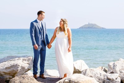 bride lifts her shoulders in a cute way in this really sunny day wedding in East Cork