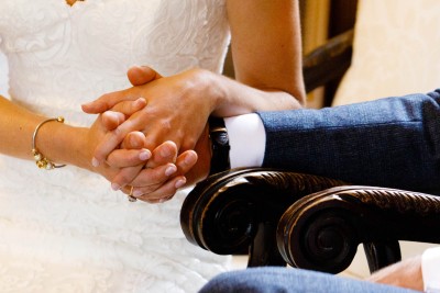 holding hands at their wedding ceremony in Waterford Castle