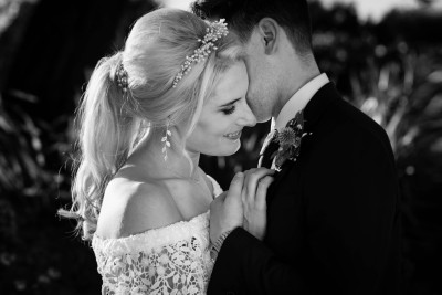 bride and groom in the evenign sunlight at their wedding in Garryvoe