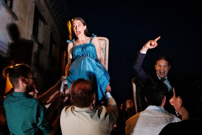 bride and groom hoisted on chairs for the Horah a traditional jewish wedding dance