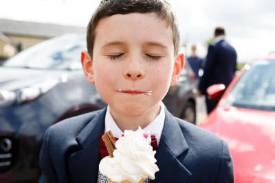 boy savours an icecream at his aunts wedding in Cork