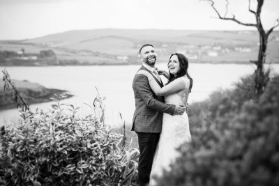 a guest shouts at the bride and groom and causes them to laugh at their wedding in Kinsale