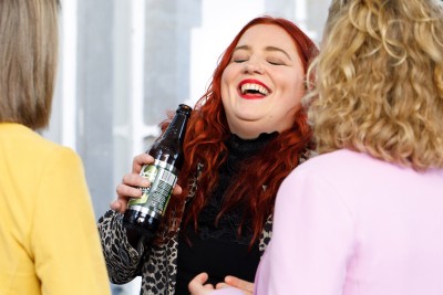 wedding guest laughing typical of the low key natural wedding photography of Claire O'Rorke