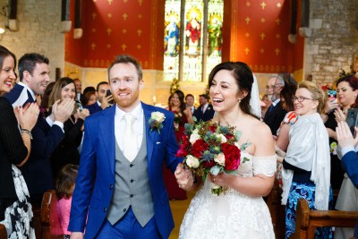 bride and groom walk down the isle at their wedding