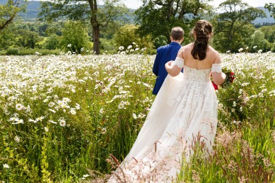 bride and groom in the wild flower meadow at Longueville House, Mallow