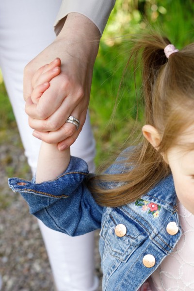 little girl grabs her mums hand during family photoshoot in Blarney Park