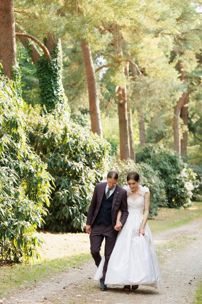 Couple take a stroll around the grounds of Blackwater Castle on their wedding day