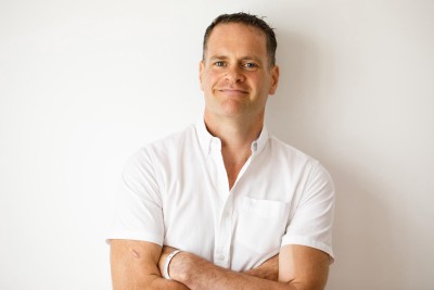 relaxed headshot of Jim O'Sullivan in white against a white background