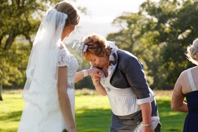 mother of bride places a kiss on her daughters wedding ring