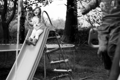 Candid child photography - kids at home - Sophie Belle on slide