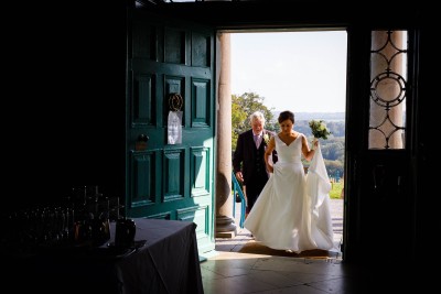 bride and groom come in the impressive front door of Longueville House, an exclusive wedding venue in Cork