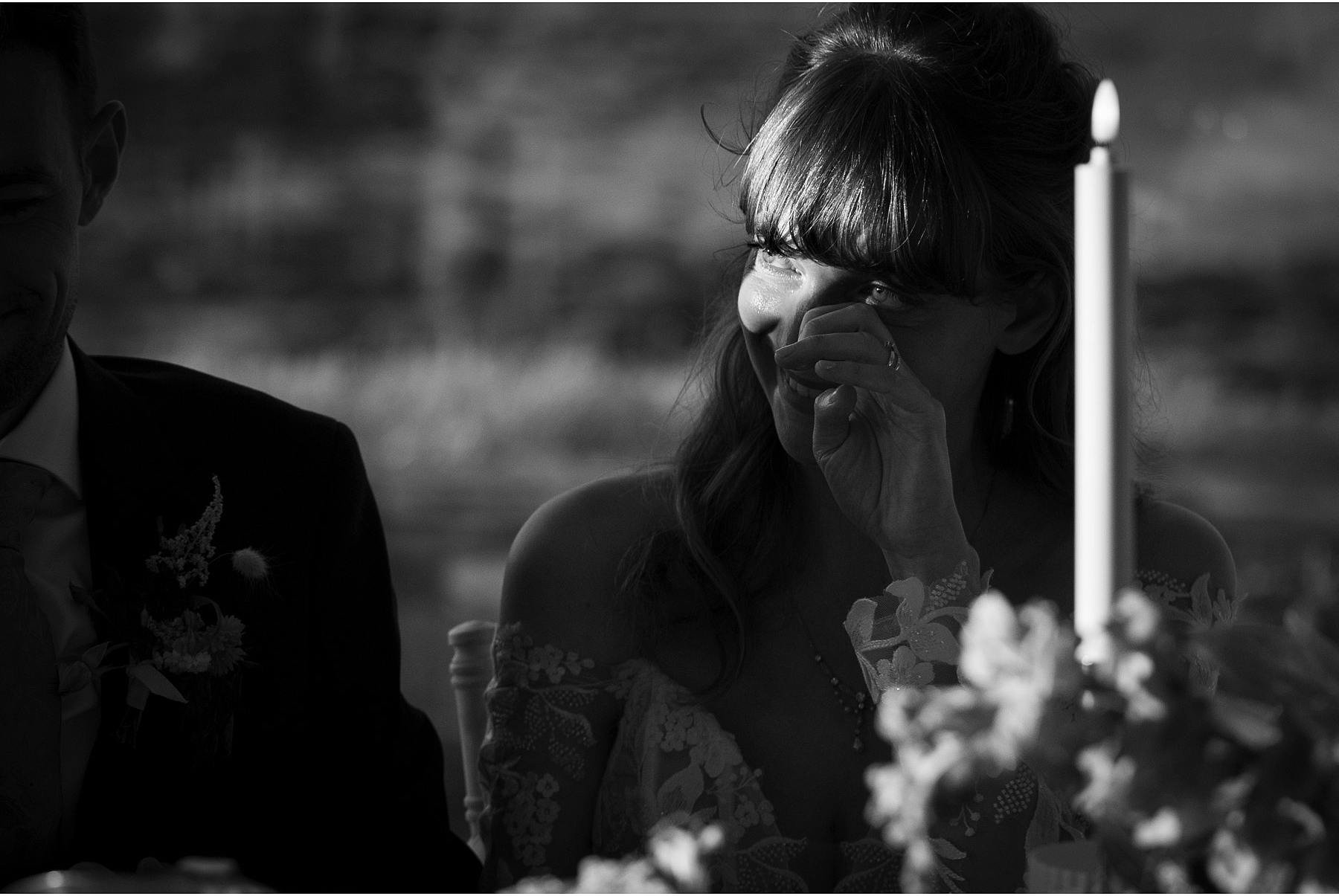 bride wipes a tear from her eye during the speeches at a wedding in Diamond Rocks in Kilkee